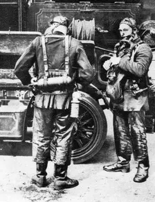 Firefighters donning smoke helmets, Farringdon Street rubber works, London, 1926-1927