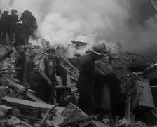 Firefighters Helping an Injured Civilian During the Blitz, 1940. Creator: British Pathe Ltd