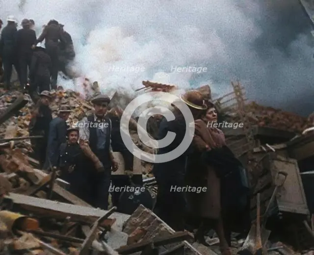 Firefighters Helping an Injured Civilian During the Blitz, 1940. Creator: British Pathe Ltd.