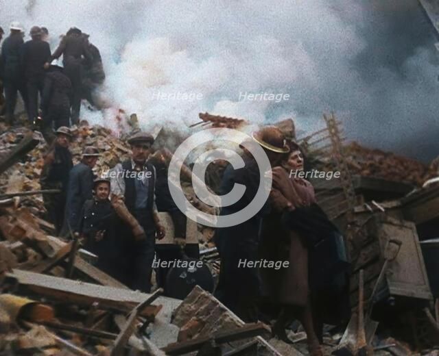 Firefighters Helping an Injured Civilian During the Blitz, 1940. Creator: British Pathe Ltd.