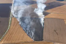 Fires in an arable field engulfing an electricty pylon, Amcotts, North Lincolnshire, 2022. Creator: Emma Trevarthen