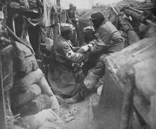 First aid to a wounded man in one of the French trenches 1915