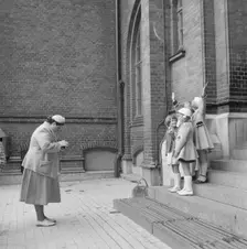 First day at school: a mother photographing her daughter and friends, Landskrona, Sweden, 1952. Creator: Unknown