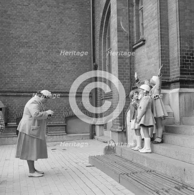 First day at school: a mother photographing her daughter and friends, Landskrona, Sweden, 1952. Creator: Unknown.
