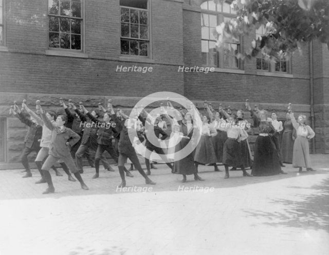 First Division school class exercising with barbells in schoolyard, Washington, D.C., (1899?). Creator: Frances Benjamin Johnston.