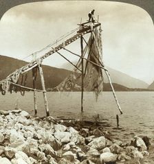 Fisherman arranging salmon nets at Balestrand on Sognefjord - Balholm in distance, Norway c1905. Creator: Unknown