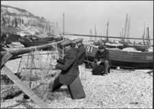 Fishermen mending nets on the beach, Hastings, East Sussex, 1925-1939. Creator: J Dixon Scott