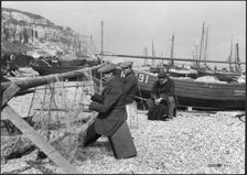 Fishermen mending nets on the beach, Hastings, East Sussex, 1925-1939. Creator: J Dixon Scott