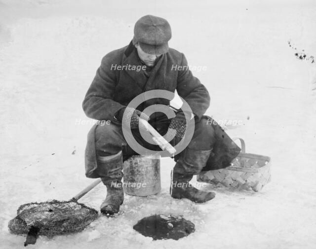 Fishing thru ice, between c1910 and c1915. Creator: Bain News Service.