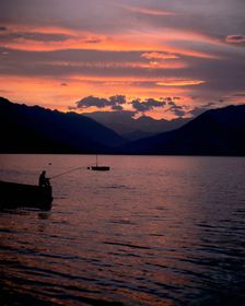 Fishing at sunset, Lake Maggiore, Italy. Creator: Peter Thompson