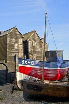 Fishing boat on the beach in front of the net shops Hastings, East Sussex, c1980-c2017. Artist: Historic England Staff Photographer