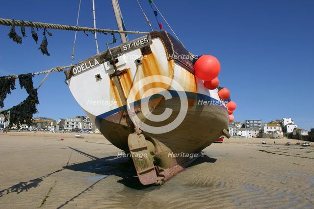 Fishing boat in the harbour at low tide, St Ives, Cornwall. Creator: Peter Thompson.
