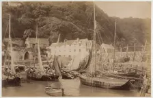 Fishing boats in the harbour at Clovelly, seen from the Pier, with the Red Lion Hotel..., c1885. Creator: James Valentine