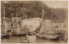 Fishing boats in the harbour at Clovelly, seen from the Pier, with the Red Lion Hotel..., c1885. Creator: James Valentine