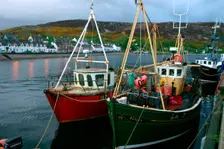 Fishing boats in Ullapool harbour at night, Highland, Scotland. Creator: Peter Thompson