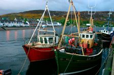 Fishing boats in Ullapool harbour at night, Highland, Scotland. Creator: Peter Thompson