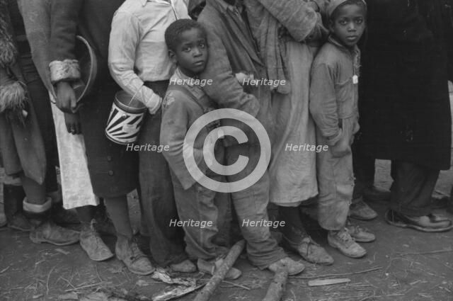 Flood refugees at mealtime, Forrest City, Arkansas, 1937. Creator: Walker Evans.