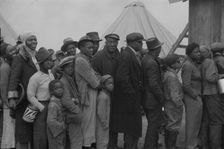 Flood refugees at mealtime, Forrest City, Arkansas, 1937. Creator: Walker Evans