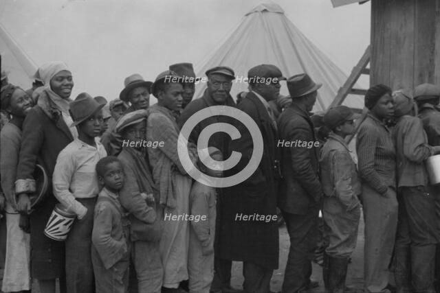 Flood refugees at mealtime, Forrest City, Arkansas, 1937. Creator: Walker Evans.