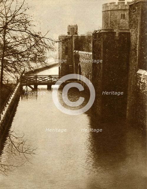 Flood waters in the moat at the Tower of London, 1928, (1935). Creator: Unknown.