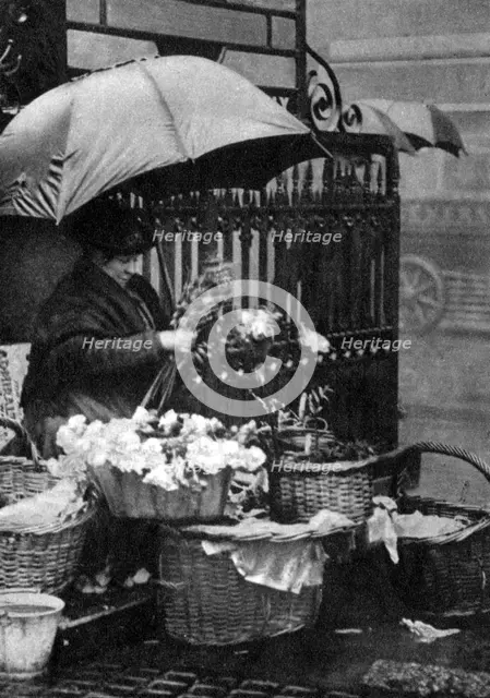 Flower seller, Piccadilly Circus, London, 1926-1927. Artist: Unknown