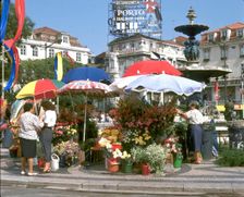 Flower sellers in the Rossio, Lisbon, Portugal. Creator: Peter Thompson