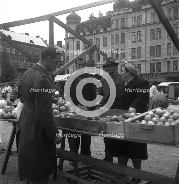 Fruit and vegetable stall in the market, Malmö, Sweden, 1947. Artist: Otto Ohm