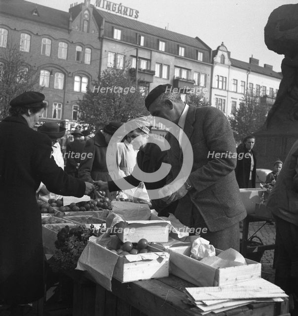 Fruit and vegetable stall in the market, Malmö, Sweden, 1947. Creator: Otto Ohm.