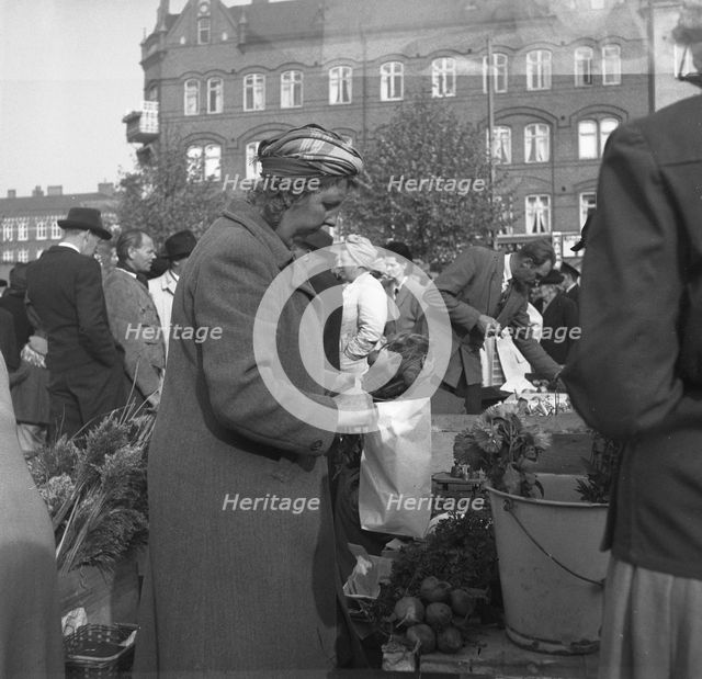 Fruit and vegetable stall in the market, Malmö, Sweden, 1947. Creator: Otto Ohm.