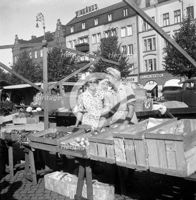 Fruit and vegetable stall in the market, Malmö, Sweden, 1947. Creator: Otto Ohm.