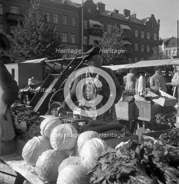 Fruit and vegetable stall in the market, Malmö, Sweden, 1947. Creator: Otto Ohm.