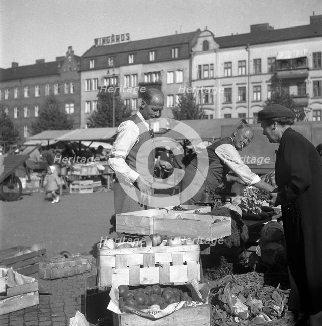 Fruit and vegetable stall in the market, Malmö, Sweden, 1947. Creator: Otto Ohm.