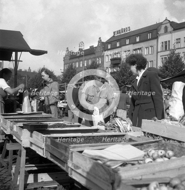 Fruit and vegetable stall in the market, Malmö, Sweden, 1947. Creator: Otto Ohm.