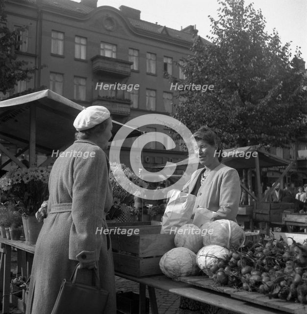 Fruit and vegetable stall in the market, Malmö, Sweden, 1947. Creator: Otto Ohm.