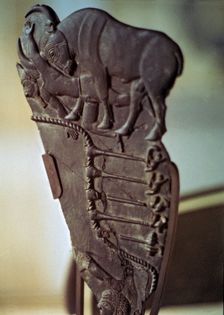 Fragment of an Egyptian palette with images of a bull fight. Made in schist