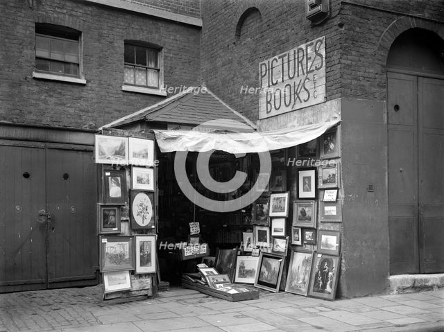 Framed pictures displayed outside a second hand book and picture shop, London, 1933.  Artist: WA Clark