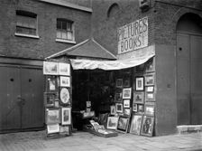 Framed pictures displayed outside a second hand book and picture shop, London, 1933. Artist: WA Clark