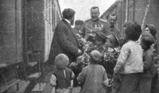 France et Russie; Un arret du train. M. Albert Thomas achete des fleurs a ces enfants..., 1916. Creator: Unknown