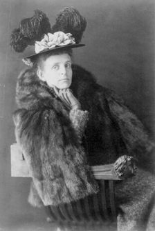 Frances Benjamin Johnston, 1864-1952, half length, seated, facing right, wearing fur jack..., 1890s. Creator: Frances Benjamin Johnston