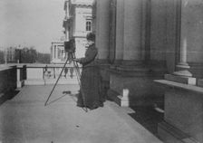 Frances Benjamin Johnston with camera on balcony of State, War and Navy Building..., 1888. Creator: Frances Benjamin Johnston