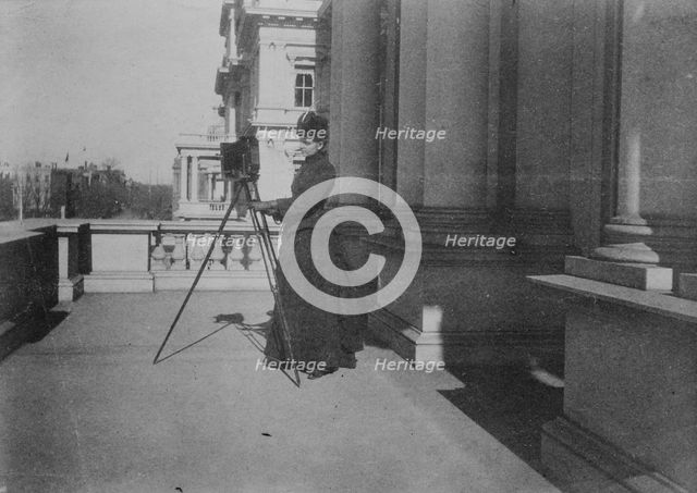 Frances Benjamin Johnston with camera on balcony of State, War and Navy Building..., 1888. Creator: Frances Benjamin Johnston.