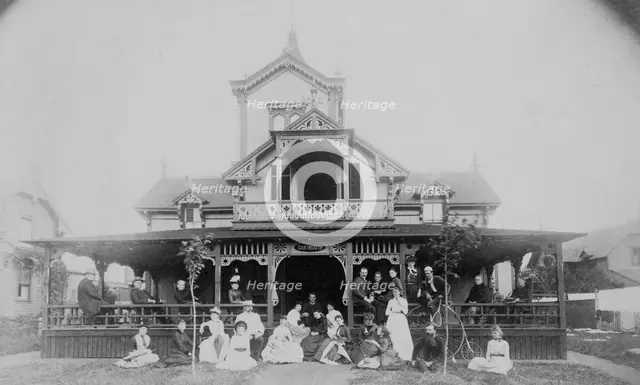Frances Benjamin Johnston and family on porch and in front of house, between 1890 and 1910. Creator: Unknown.