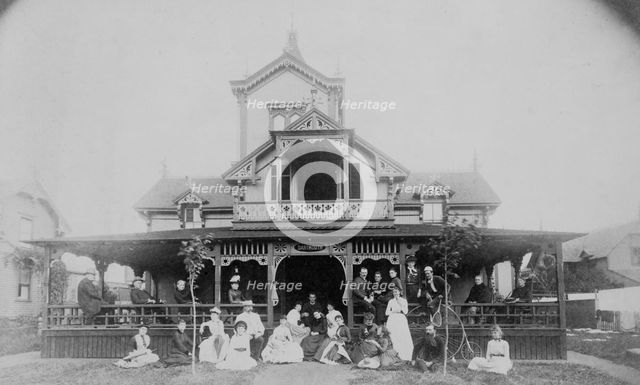 Frances Benjamin Johnston and family on porch and in front of house, between 1890 and 1910. Creator: Unknown.