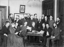 Frances Benjamin Johnston and Washington Camera Club looking at pictures, c1890. Creator: Frances Benjamin Johnston