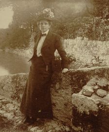 Frances Benjamin Johnston, full-length portrait, posing by a..., Cadenabbia, Lake Como, Italy, 1900. Creator: Unknown