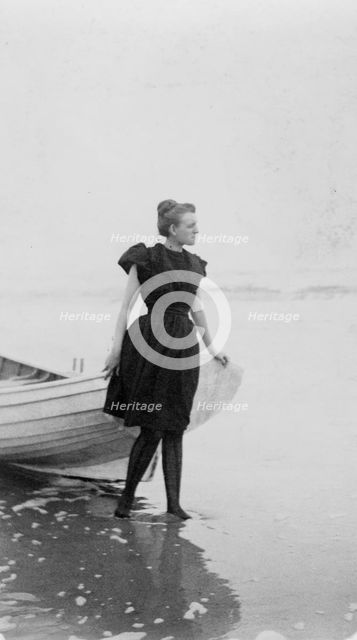 Frances Benjamin Johnston, full-length portrait, standing at edge of ocean, in..., c1880 - 1900. Creator: Unknown.