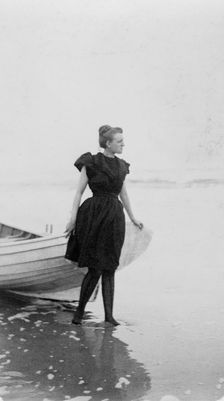 Frances Benjamin Johnston, full-length portrait, standing at edge of ocean, in..., c1880 - 1900. Creator: Unknown