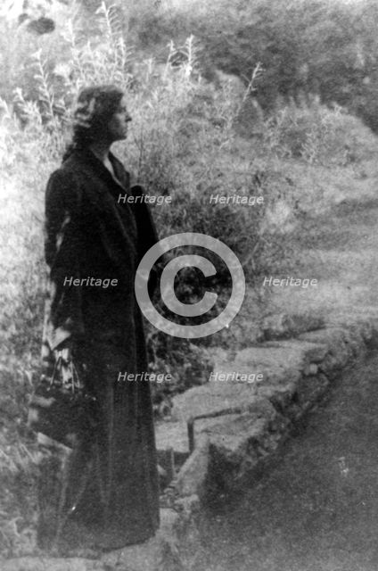 Frances Benjamin Johnston, full-length portrait, standing in garden, right profile, c1880 - 1950. Creator: Gertrude Kasebier.