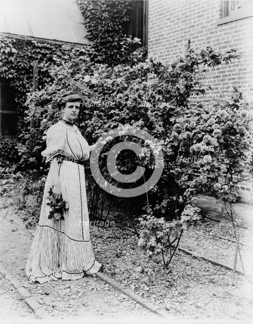 Frances Benjamin Johnston, full-length portrait, standing in her garden..., c1890 - 1910. Creator: Unknown.