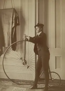 Frances Benjamin Johnston, full-length self-portrait dressed as a man with false..., c1890 - 1900. Creator: Frances Benjamin Johnston